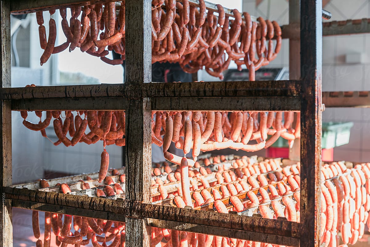 Closeup of many sausages hanging  on a meat rack