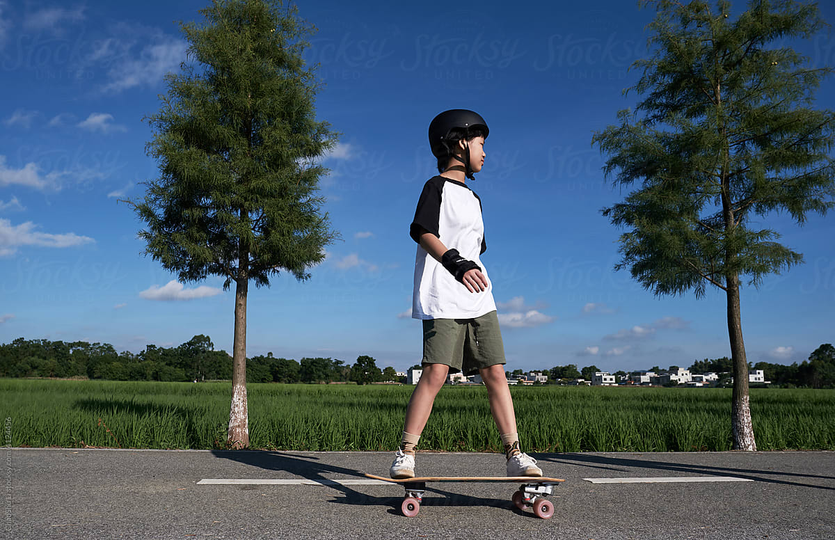 Asian little girl playing skateboard