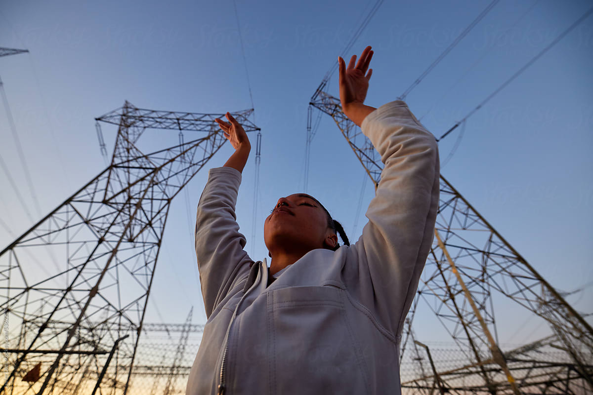 Cool woman against transmission tower
