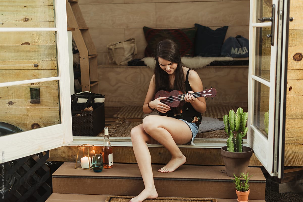 Young woman playing the ukulele