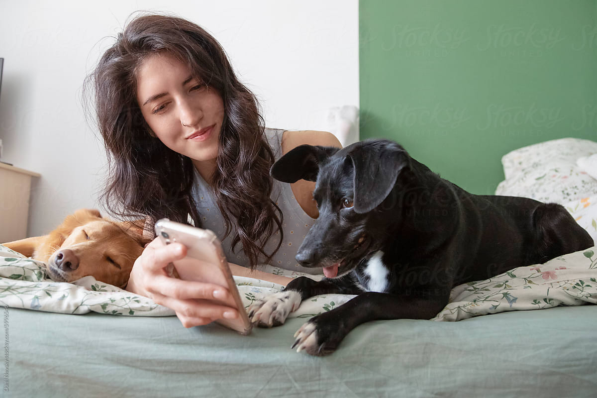 Woman with Dogs Enjoying Technology