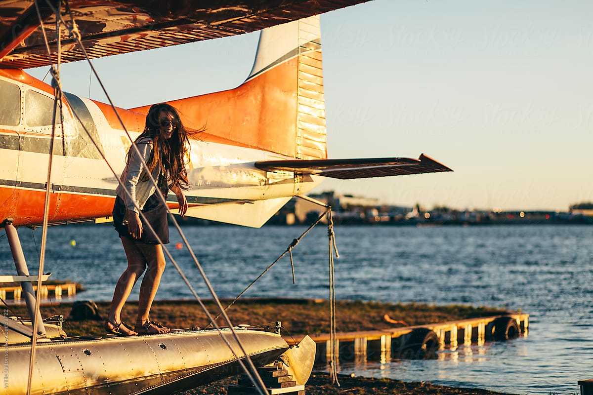 Young Woman Laughing on Sea Plane Float