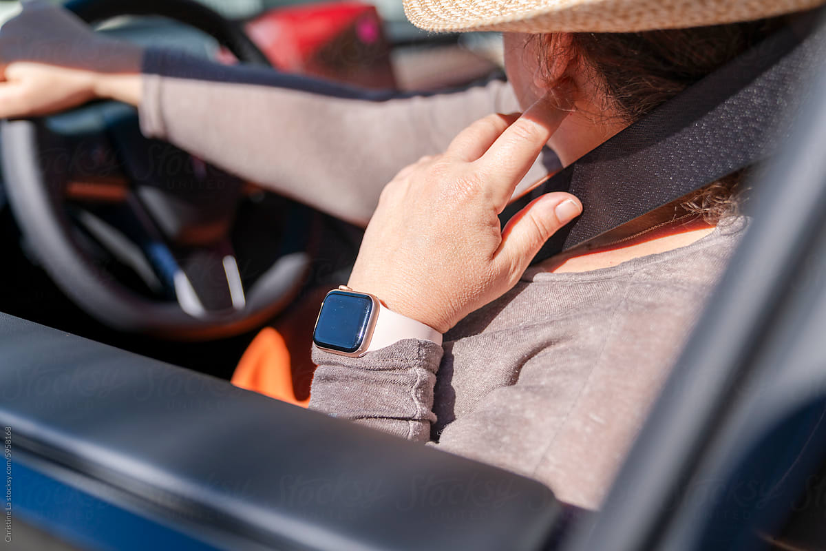 Woman wearing smart watch in car