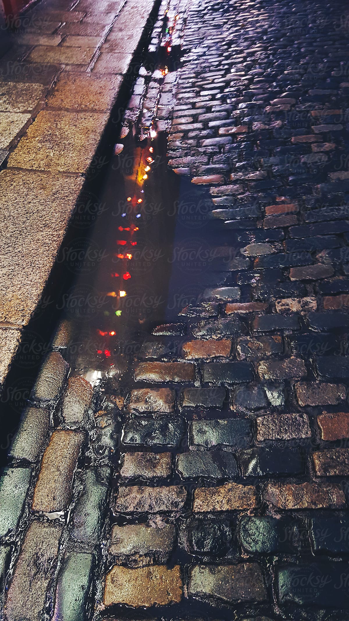 Bright lights reflected...in a puddle on Cobblestones in Dublin City, Ireland