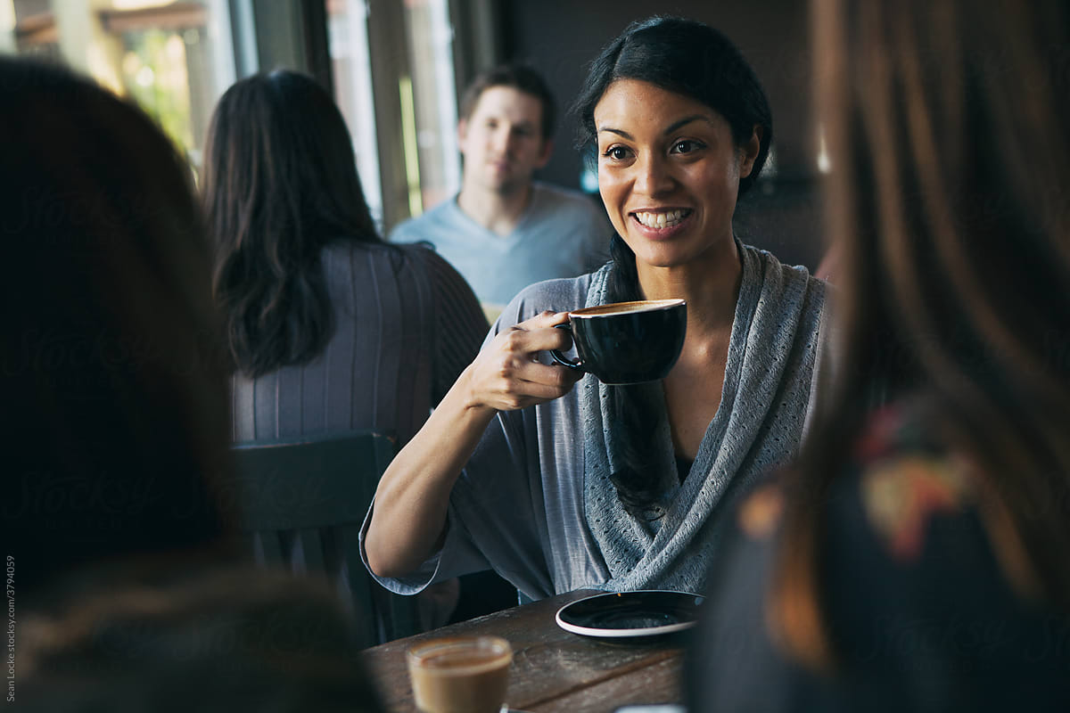 Cafe: Woman Having Discussion With Friends In Coffee Shop