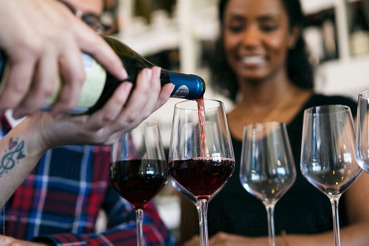 Wine: Shop Owner Pours Sample Of Red Wine For Customers