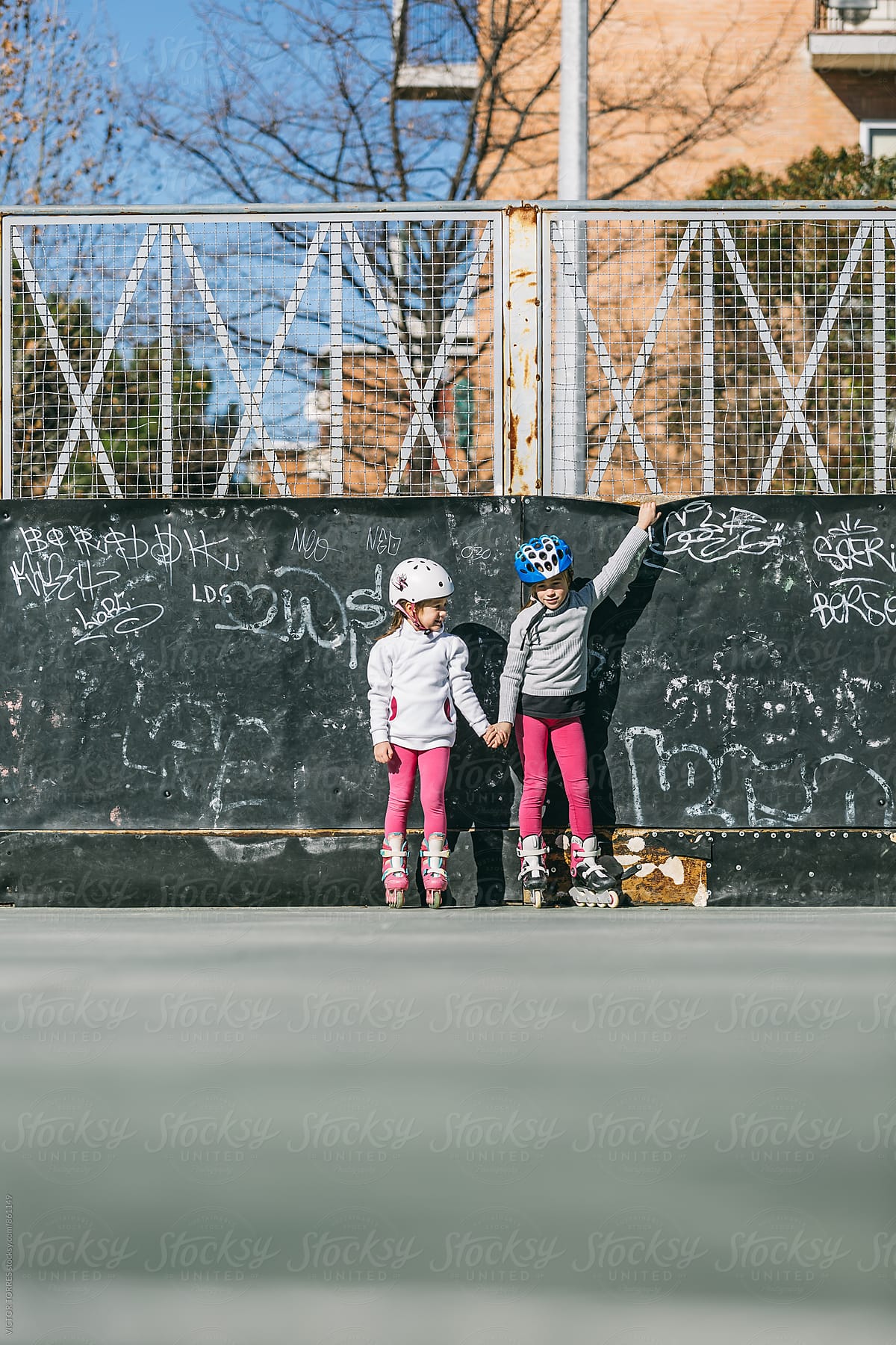 Two Sisters Having a Break During a Rollerblading Exercise