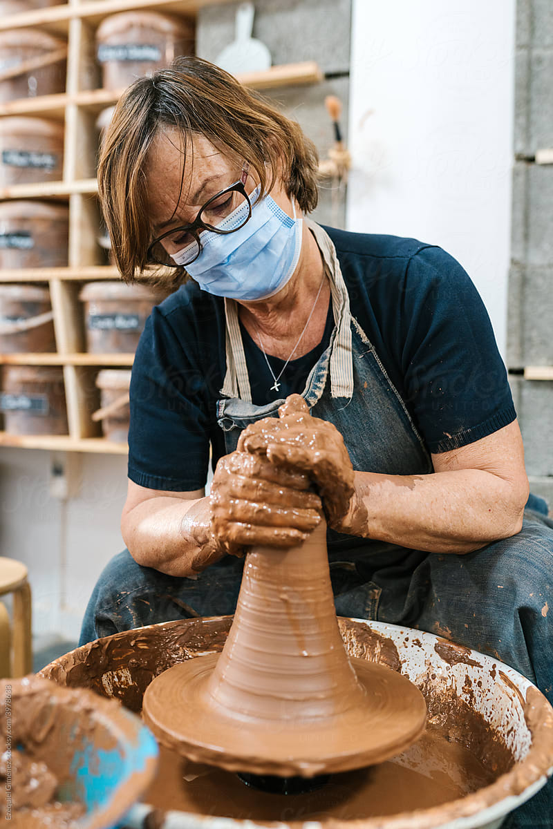 Woman shaping a piece of clay at the pottery