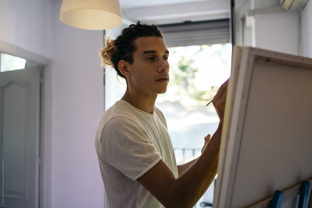Concentrated artist painting a canvas
