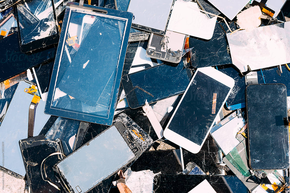 Broken tablet and cell phone screens on a pile