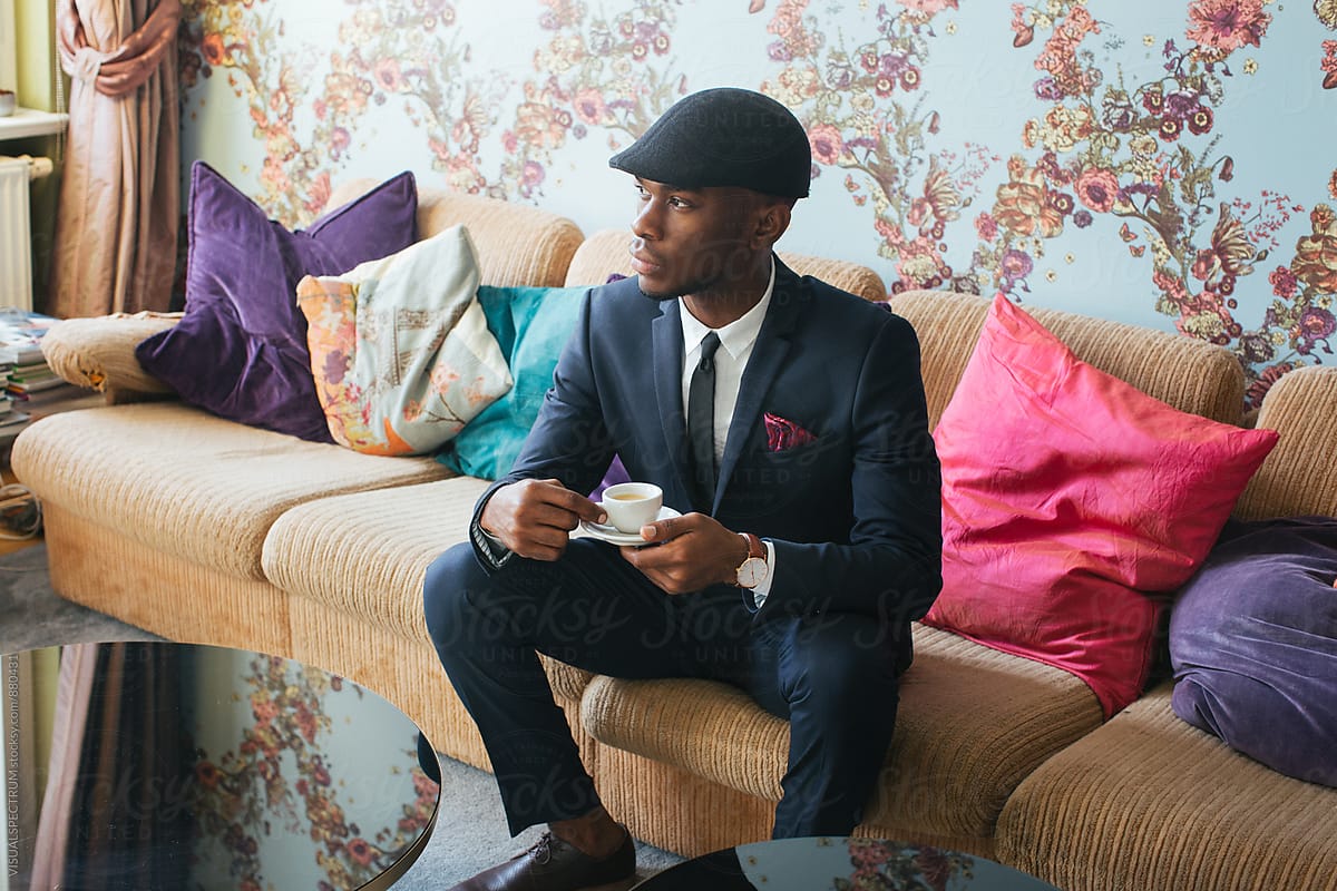 «Elegant Young Black Man Sitting In Stylish Living Room And Drinking ...