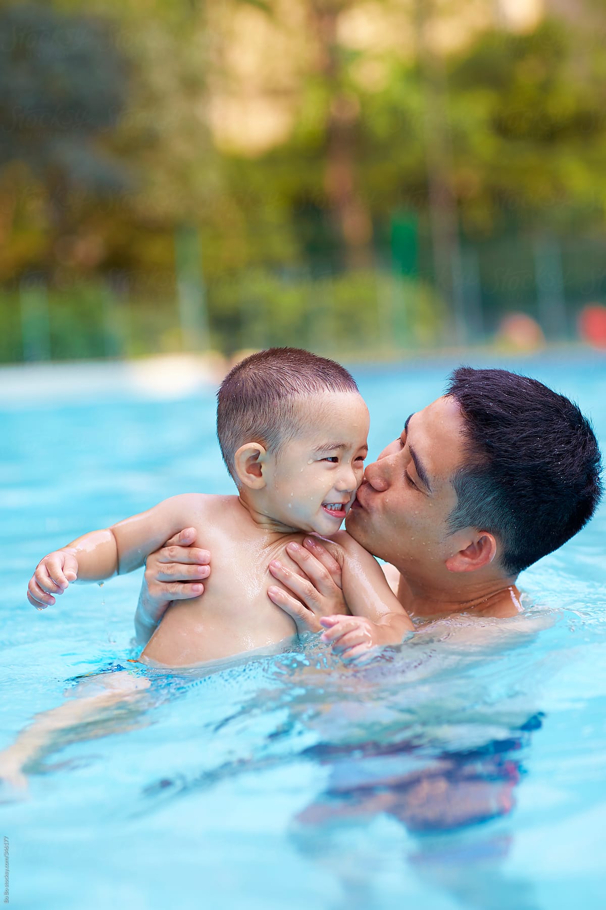 father and baby boy in swimming pool