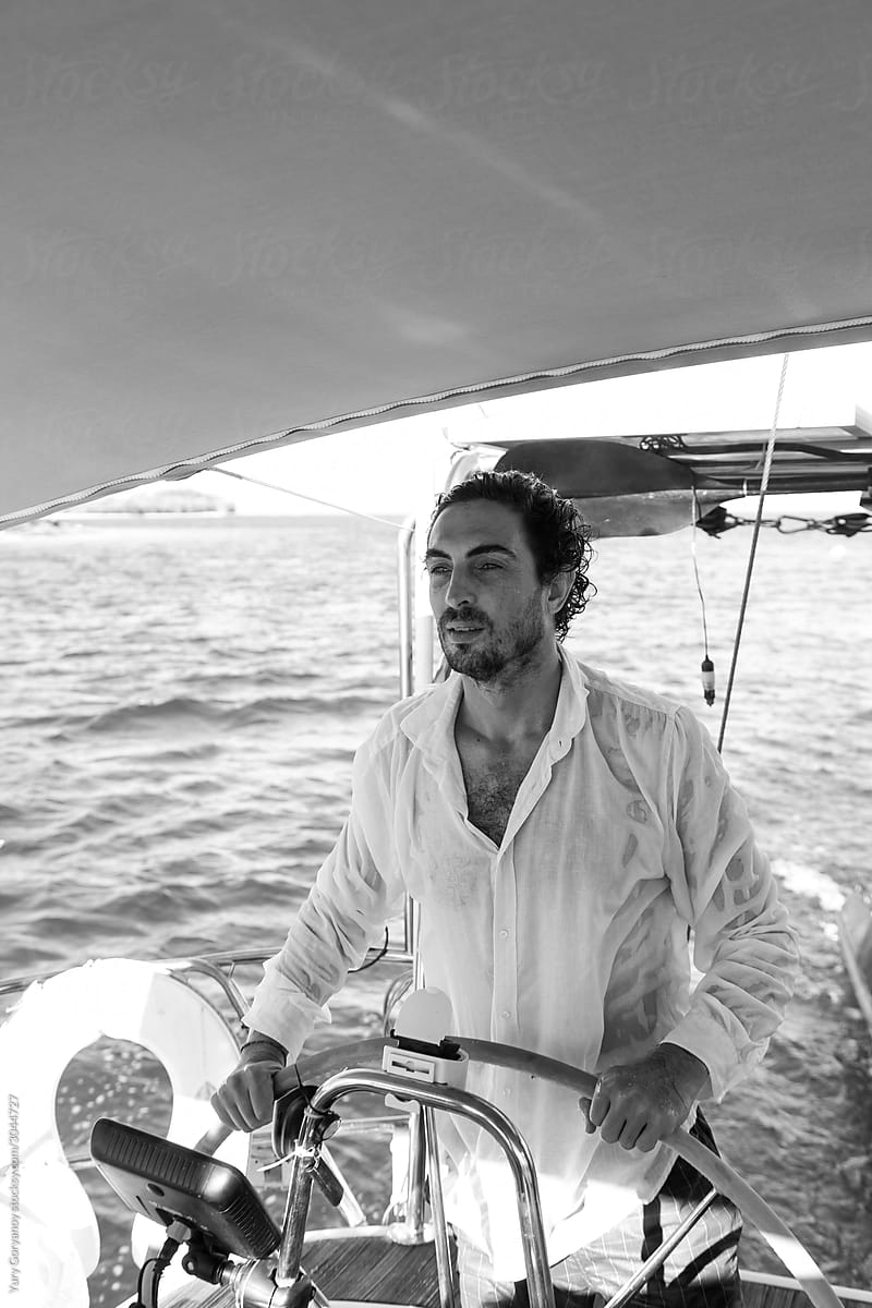 Portrait of a man at the helm of a yacht