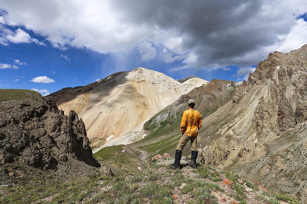 Man Looking Out Over Mountains On Hike Outdoors by Stocksy Contributor Matthew  Spaulding - Stocksy