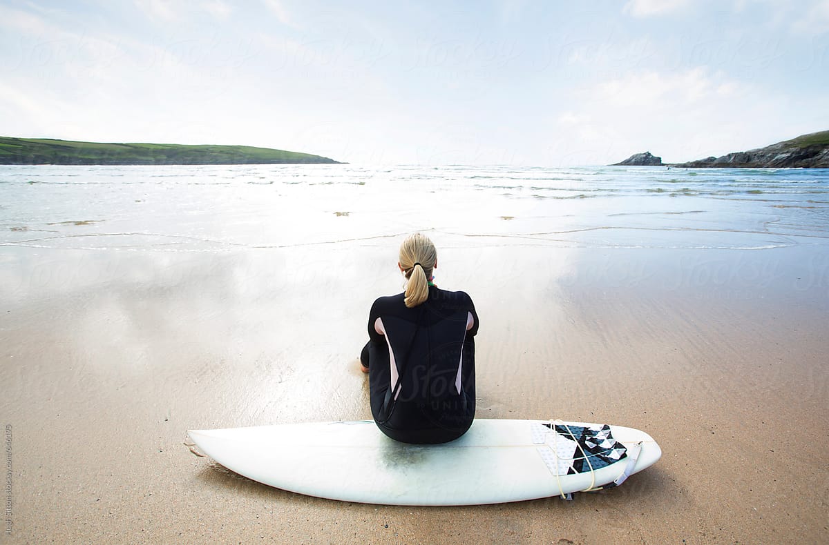 Female Surfer Sitting On Surfboard By Stocksy Contributor Hugh Sitton Stocksy