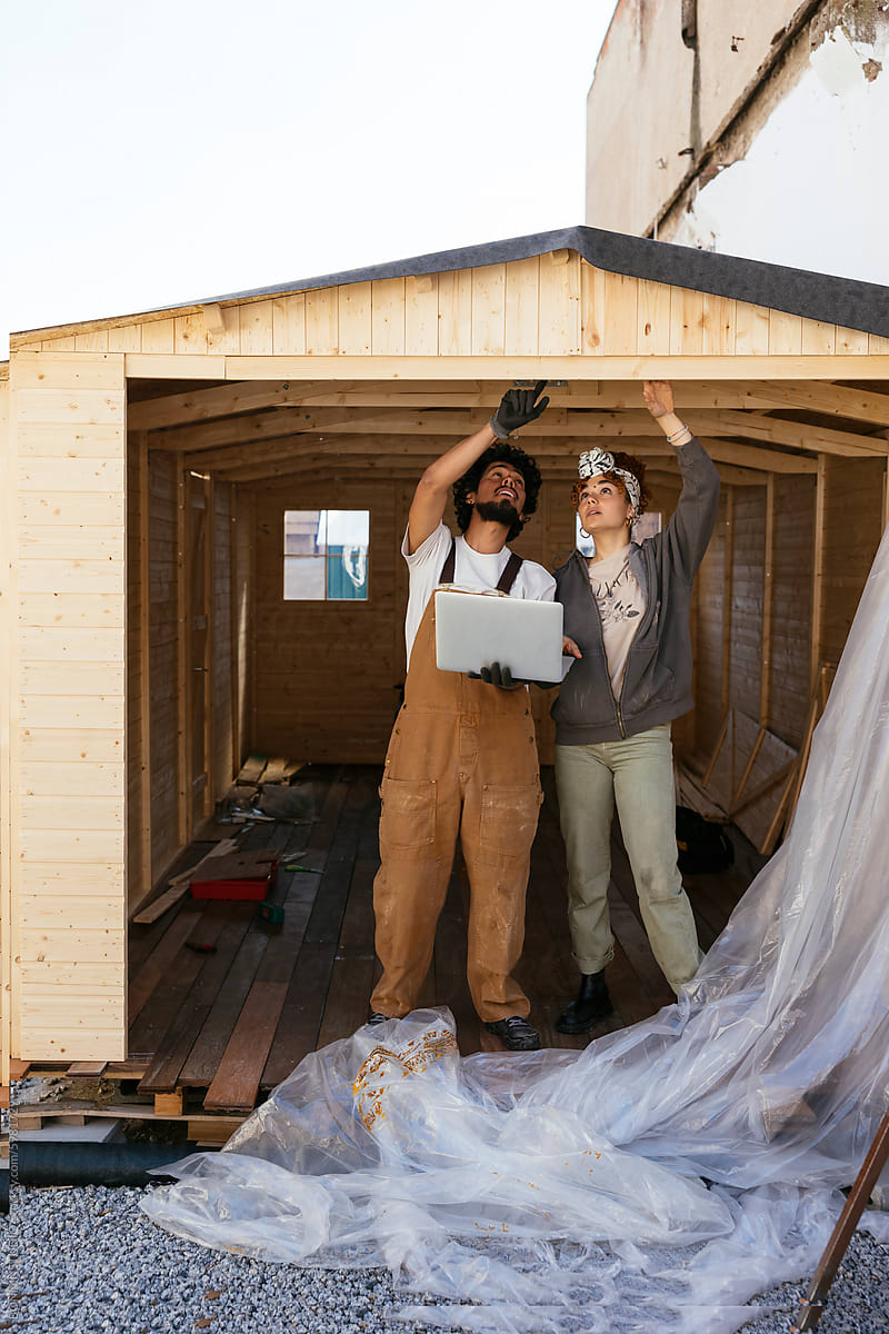 Volunteers building a wooden greenhouse