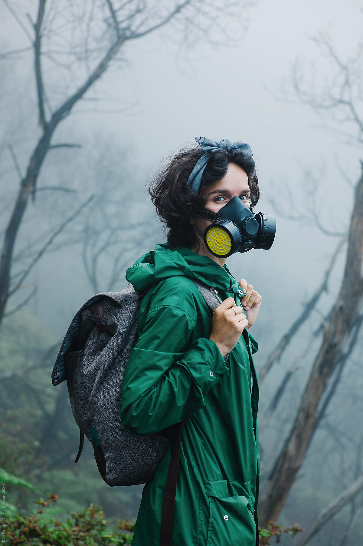 Female in mask walking on volcano