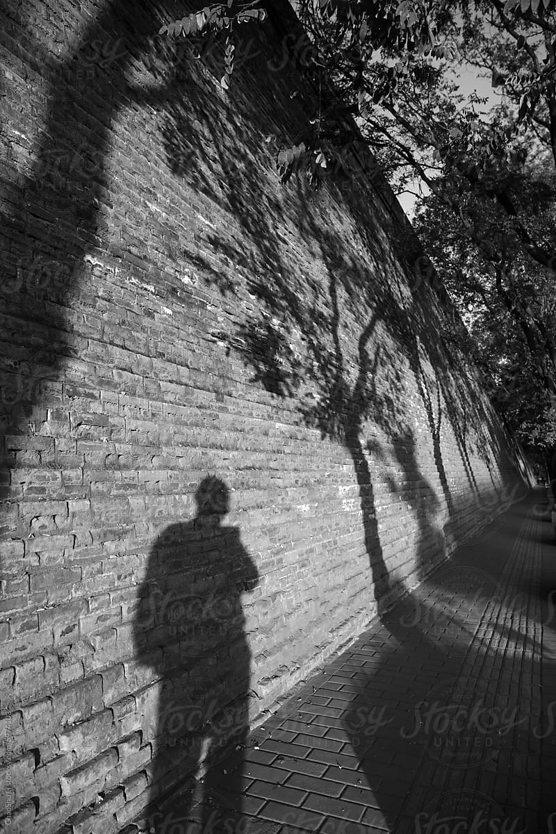 China\'s centuries-old ancient city wall and silhouettes of people