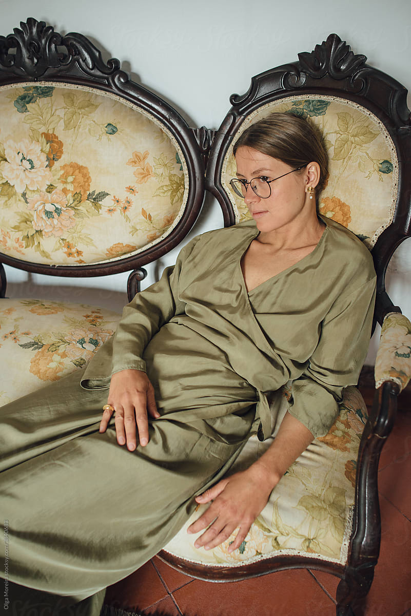 Portrait of a relaxed woman on an old style sofa