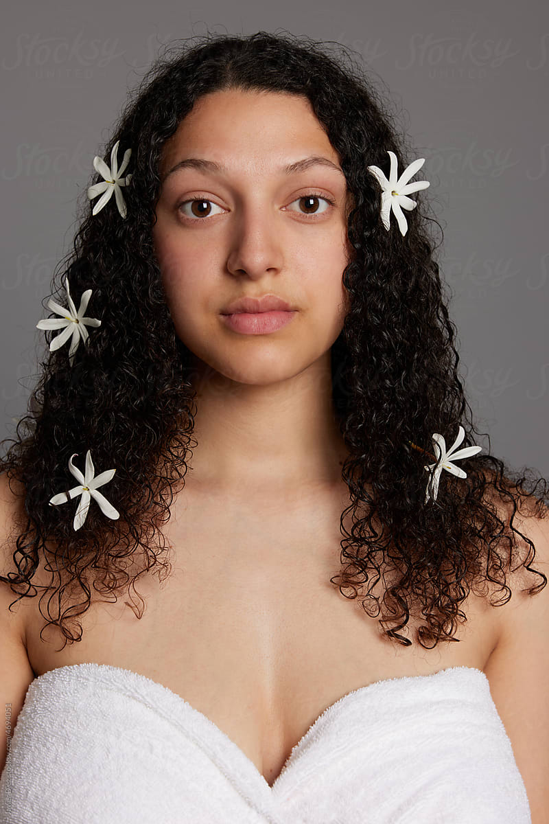 Woman with bare shoulders and flowers in hair