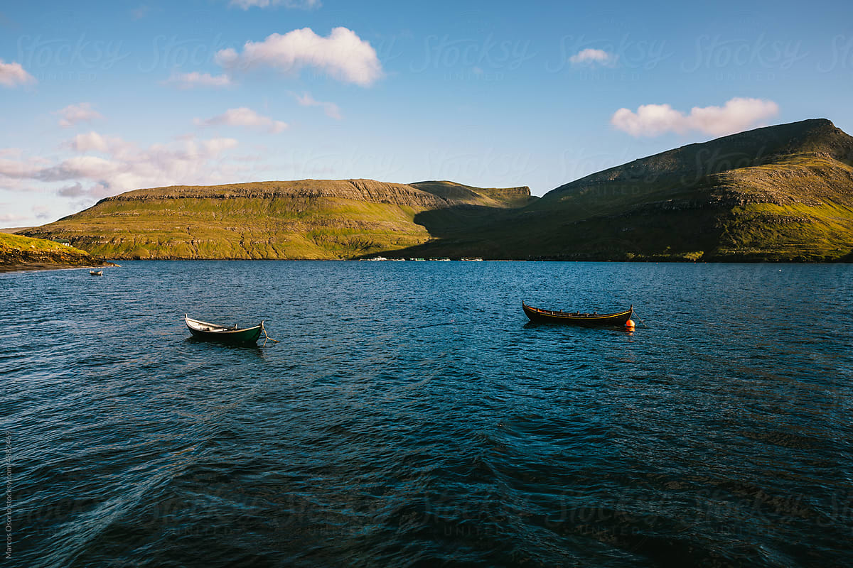 Small boats in the middle of the sea in the Faroe Islands