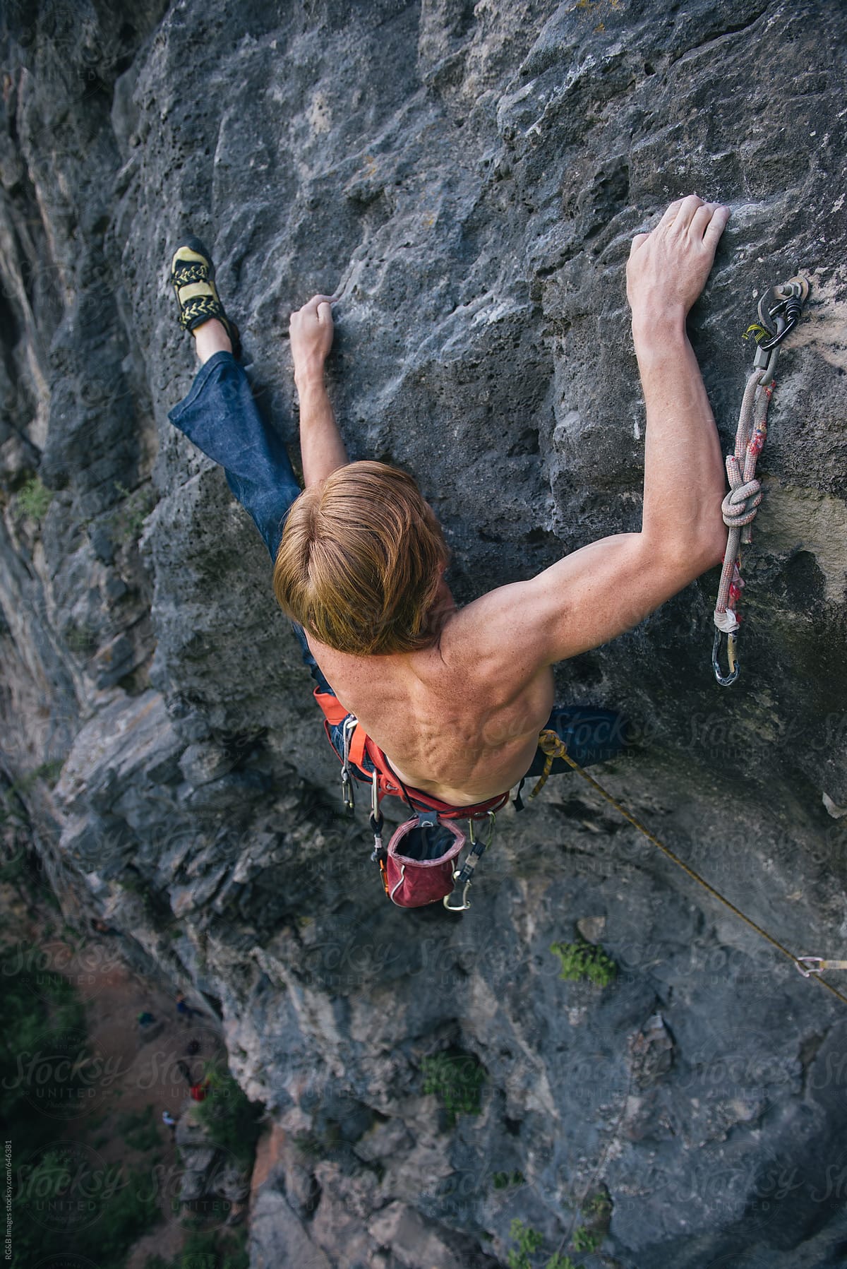 Male climber using his heel to hold on the rock