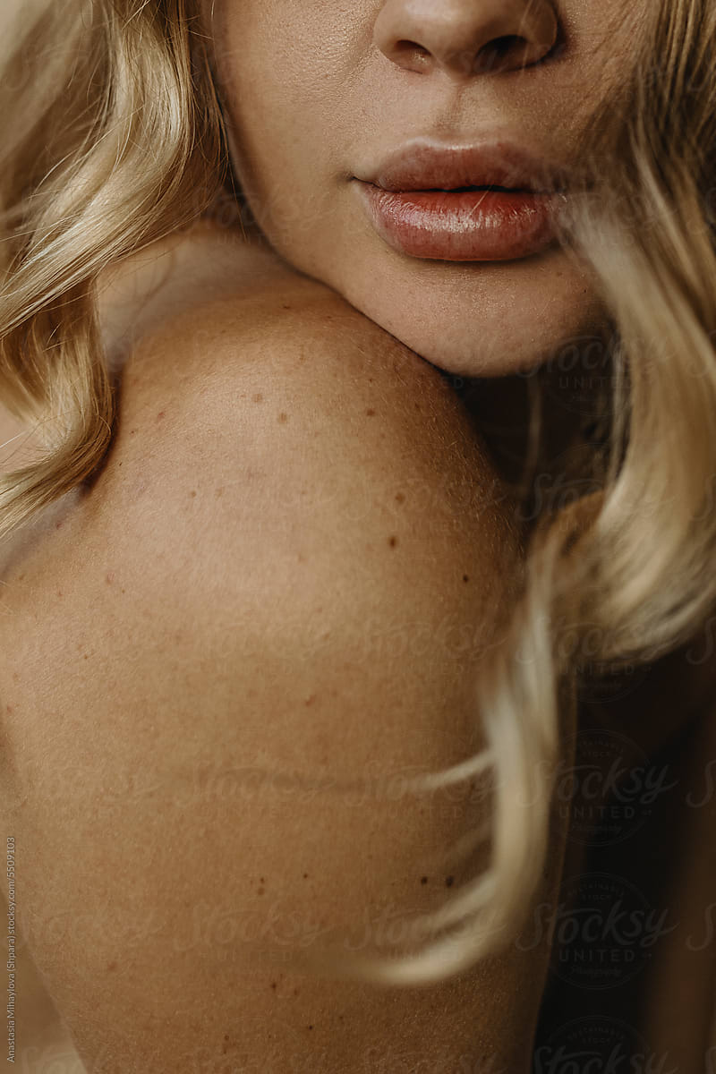 Close up of sensual big plump lips of anonymous blonde woman