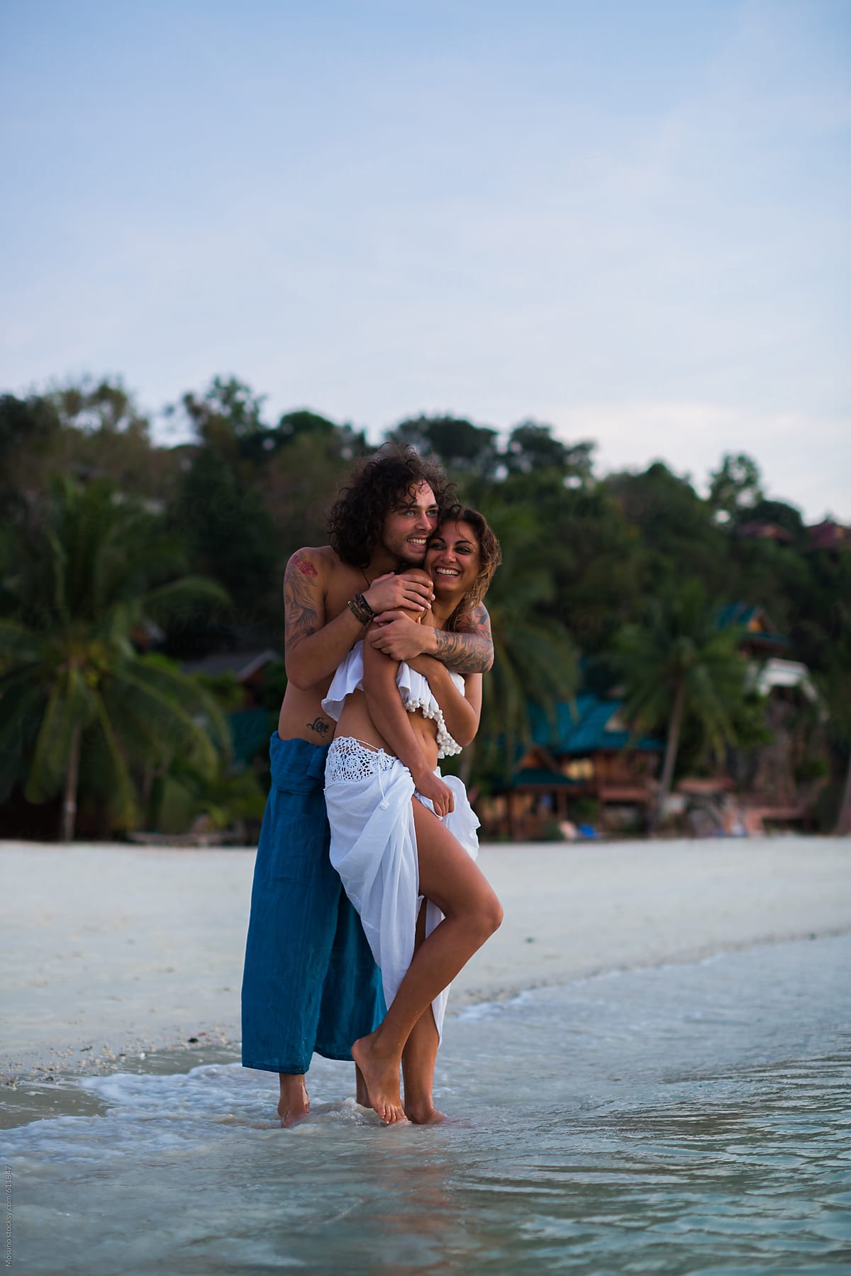 Happy Couple Hugging By The Sea By Stocksy Contributor Mosuno Stocksy 