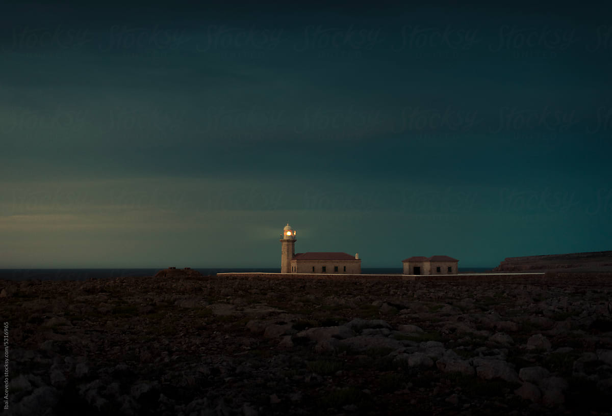 Cinematic lighthouse during dramatic dark sunset