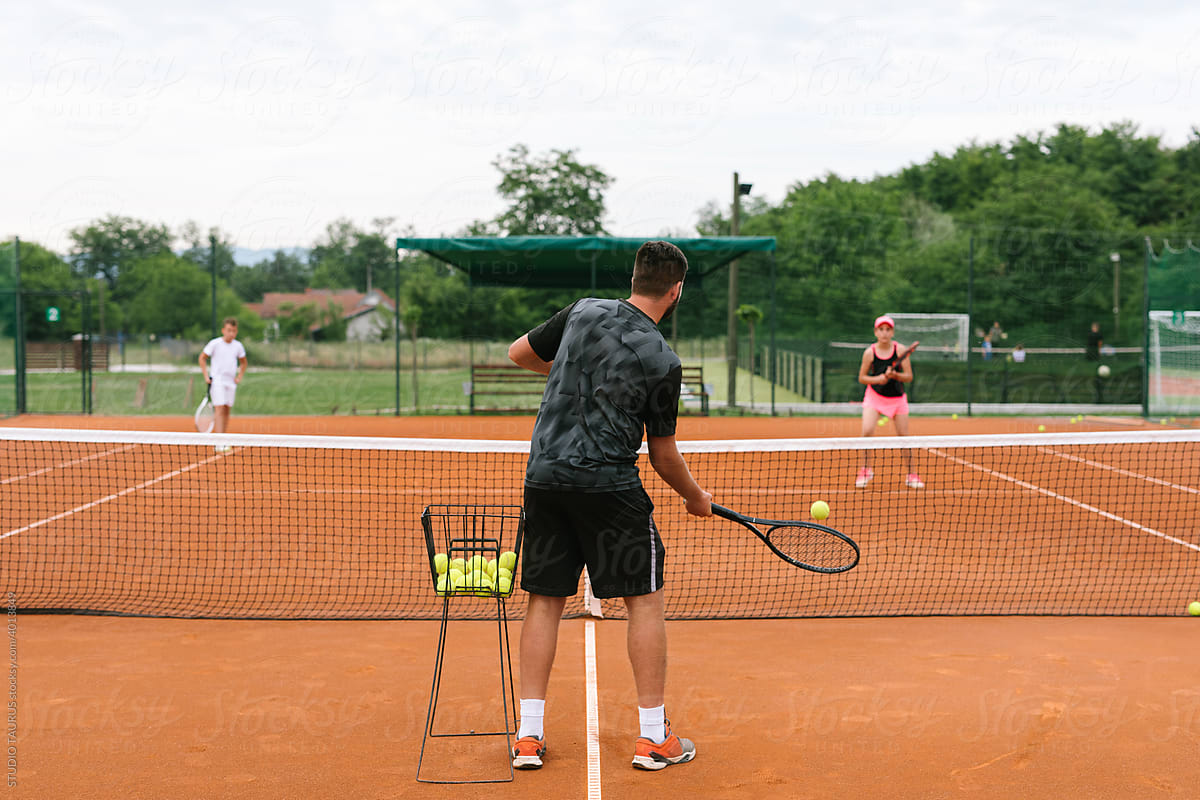 Girl And Her Coach Playing Tennis
