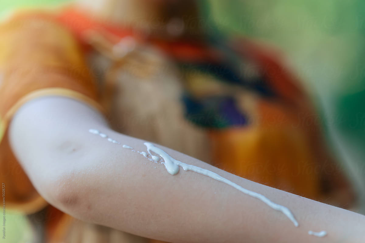 sunscreen lotion on arm
