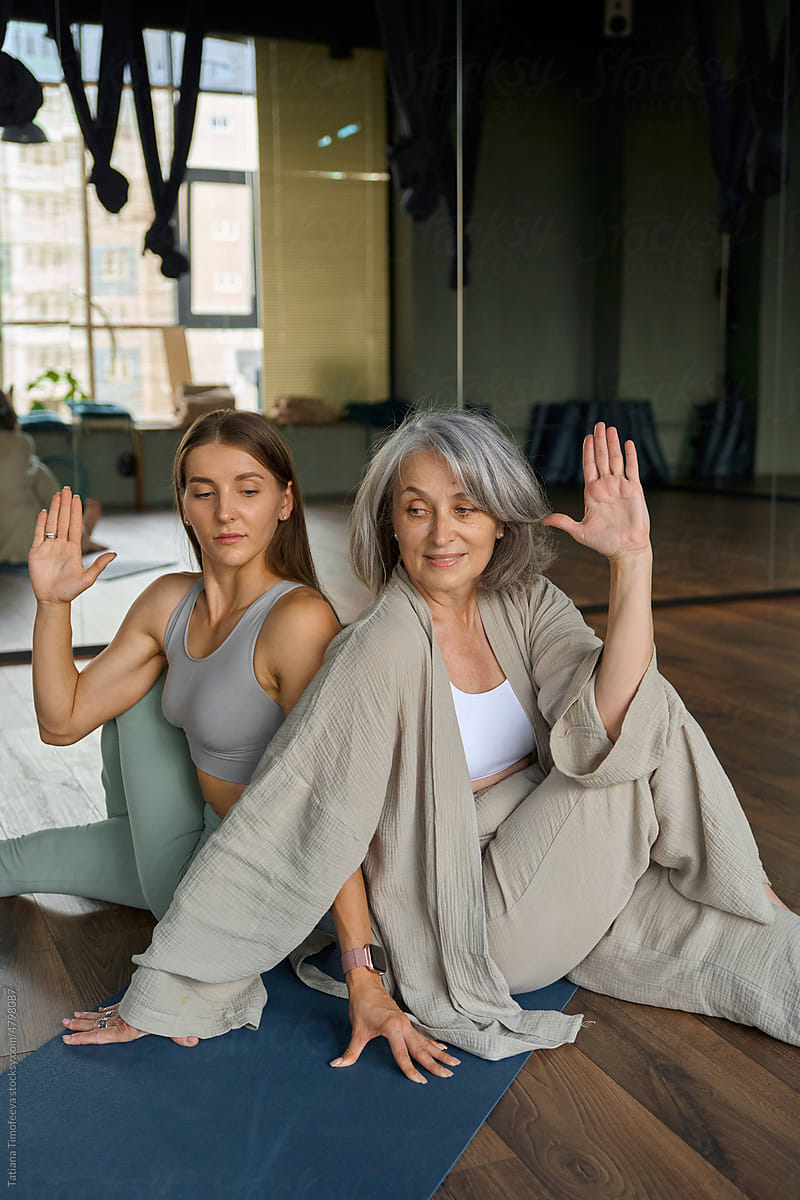 Mom and adult daughter on yoga