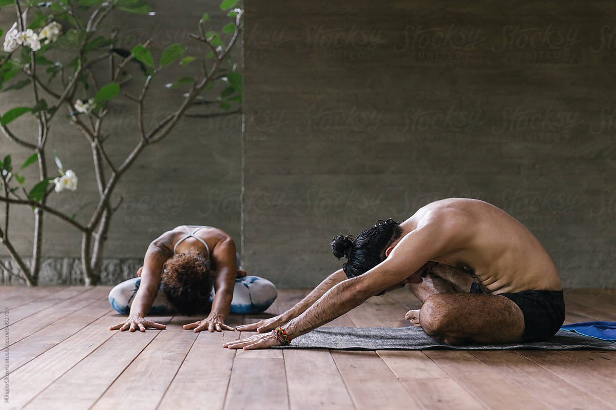 Two people doing yoga together