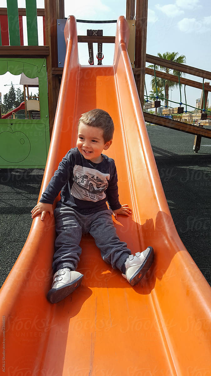 Little boy sliding down the slide