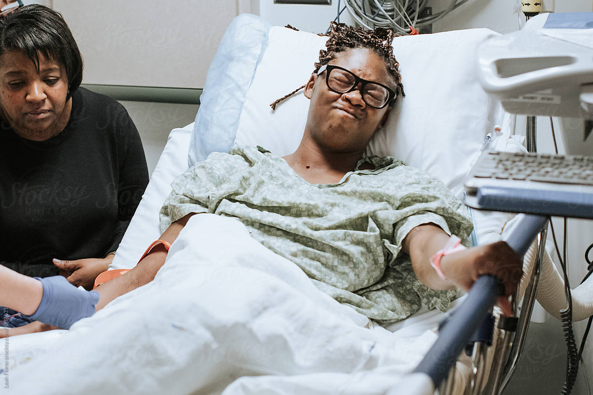 Patient in Pain at Hospital Gripping Hospital Bed