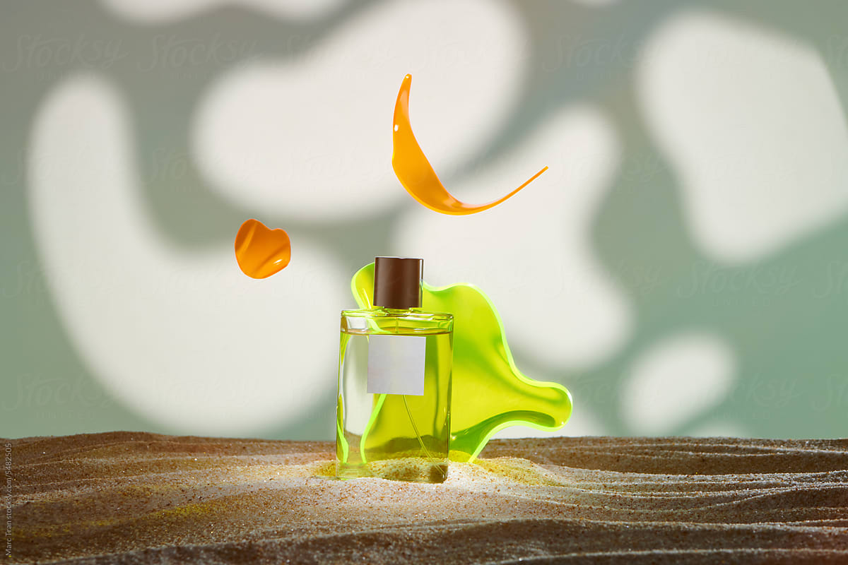White perfume glass bottle on clean beach sand