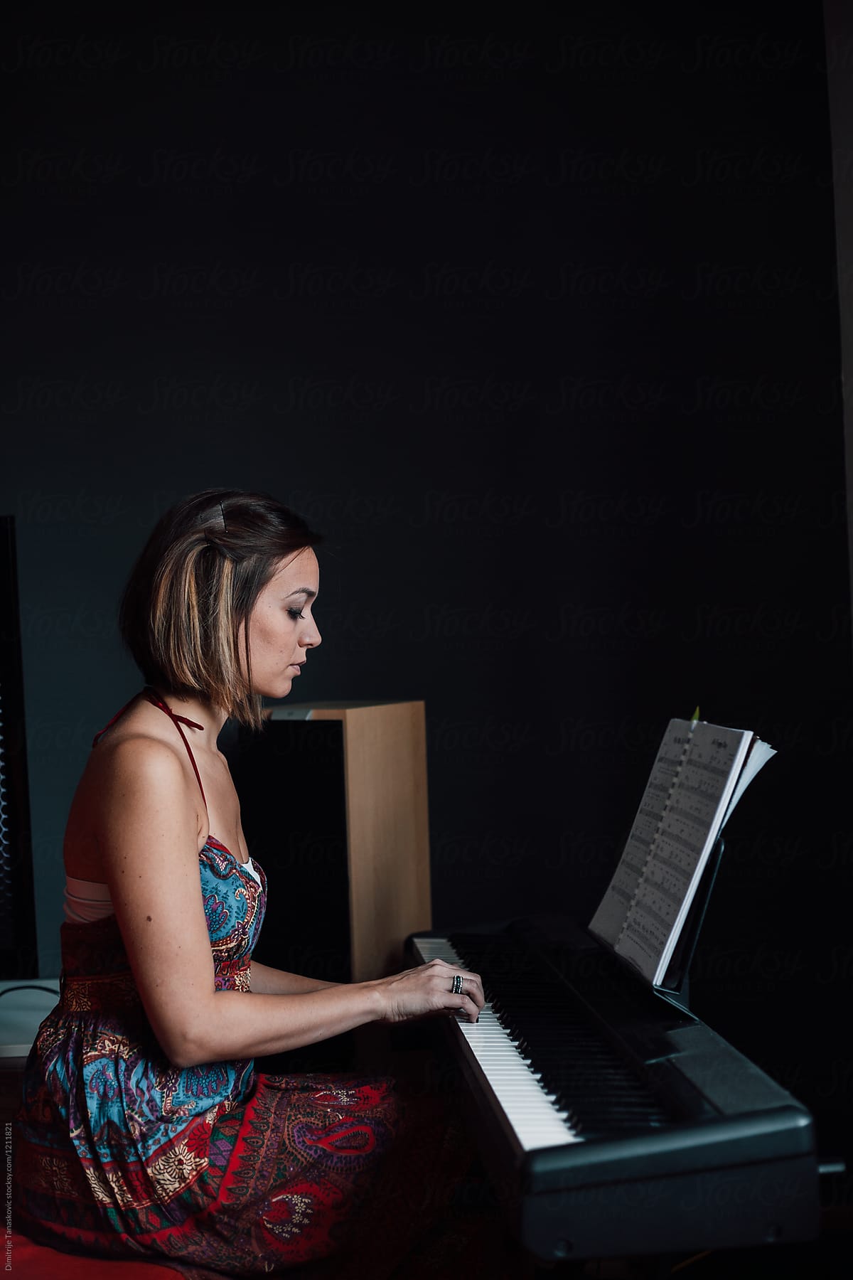 Woman Playing Piano At Home.