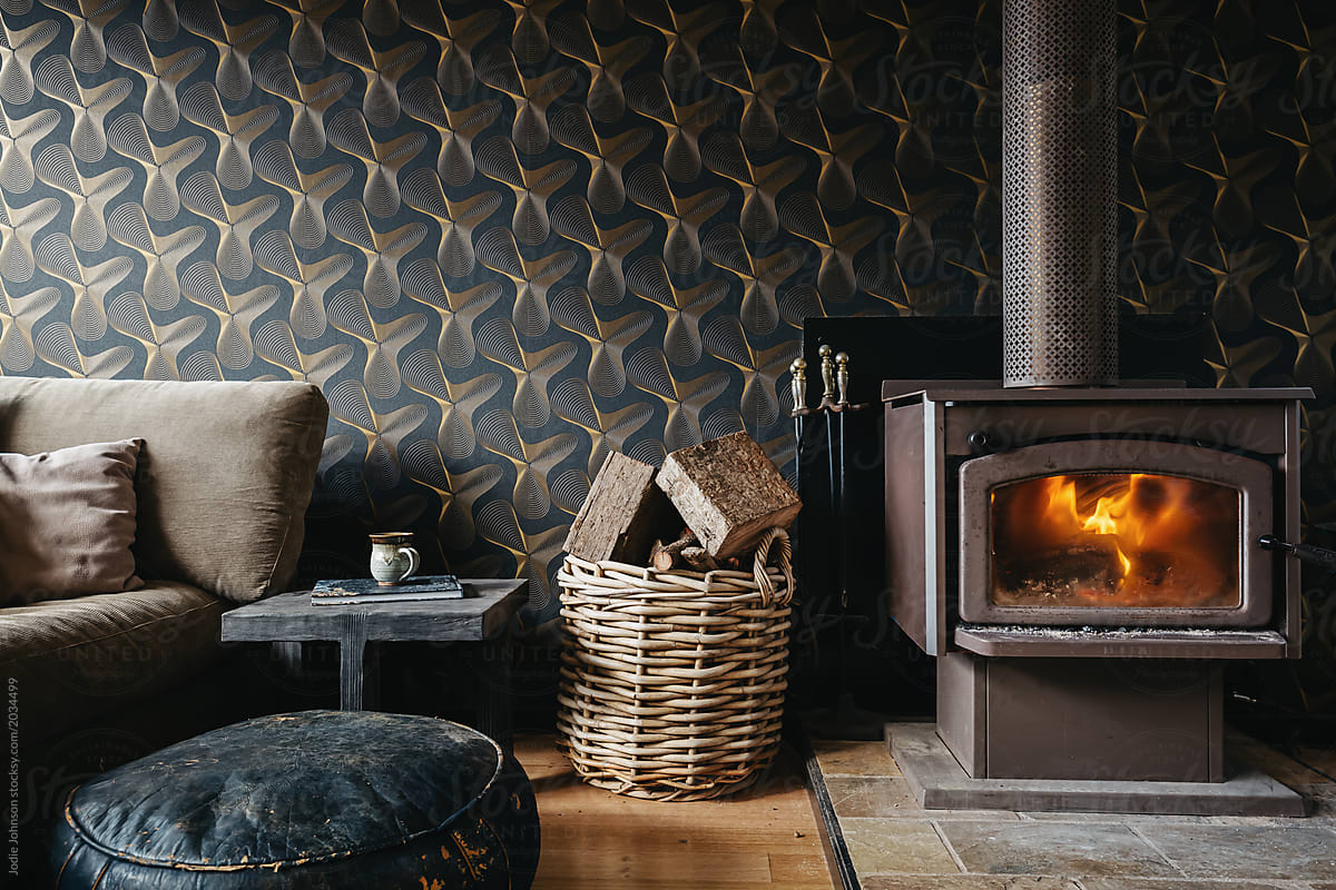 Cosy interior of a log fire and dark wallpaper