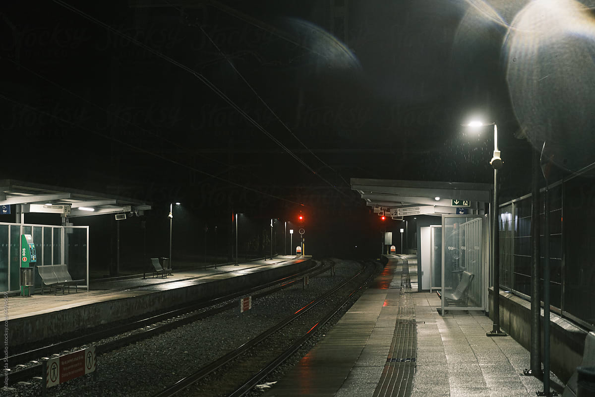 Tracks of train station a rainy night