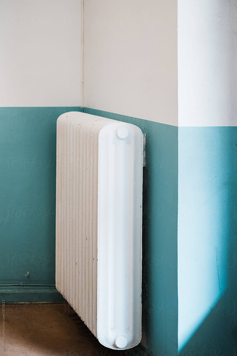 Heat radiator on a blue and white wall
