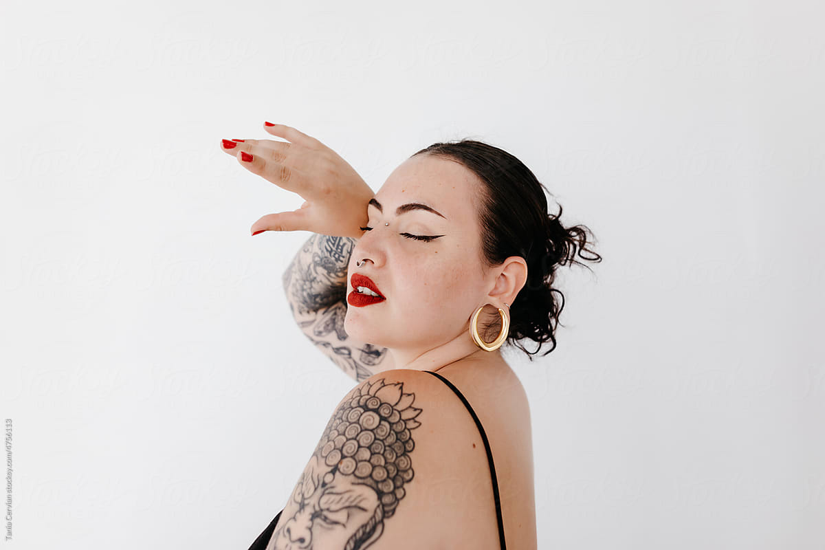 Stylish tattooed woman with makeup