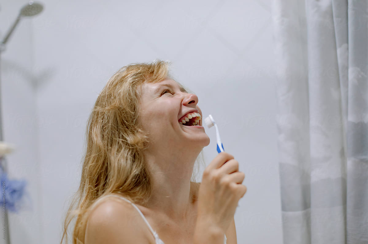 girl with a toothbrush in the bathroom