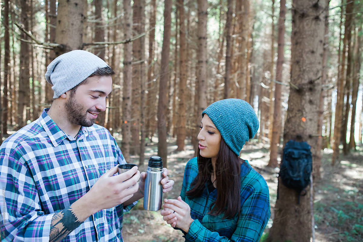 Couple Drinking Hot Tea In The Woods