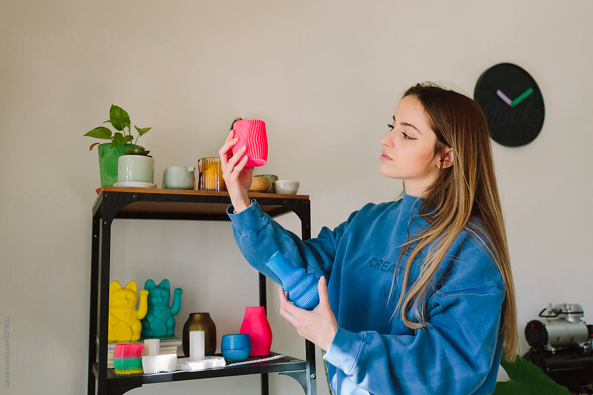Woman looking at a 3D-printed vase