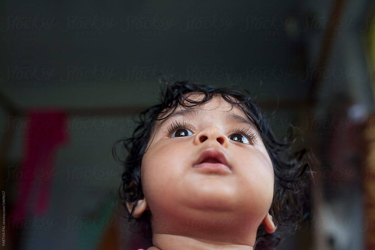 Cute Baby looking upwards,low angle view with window light falling