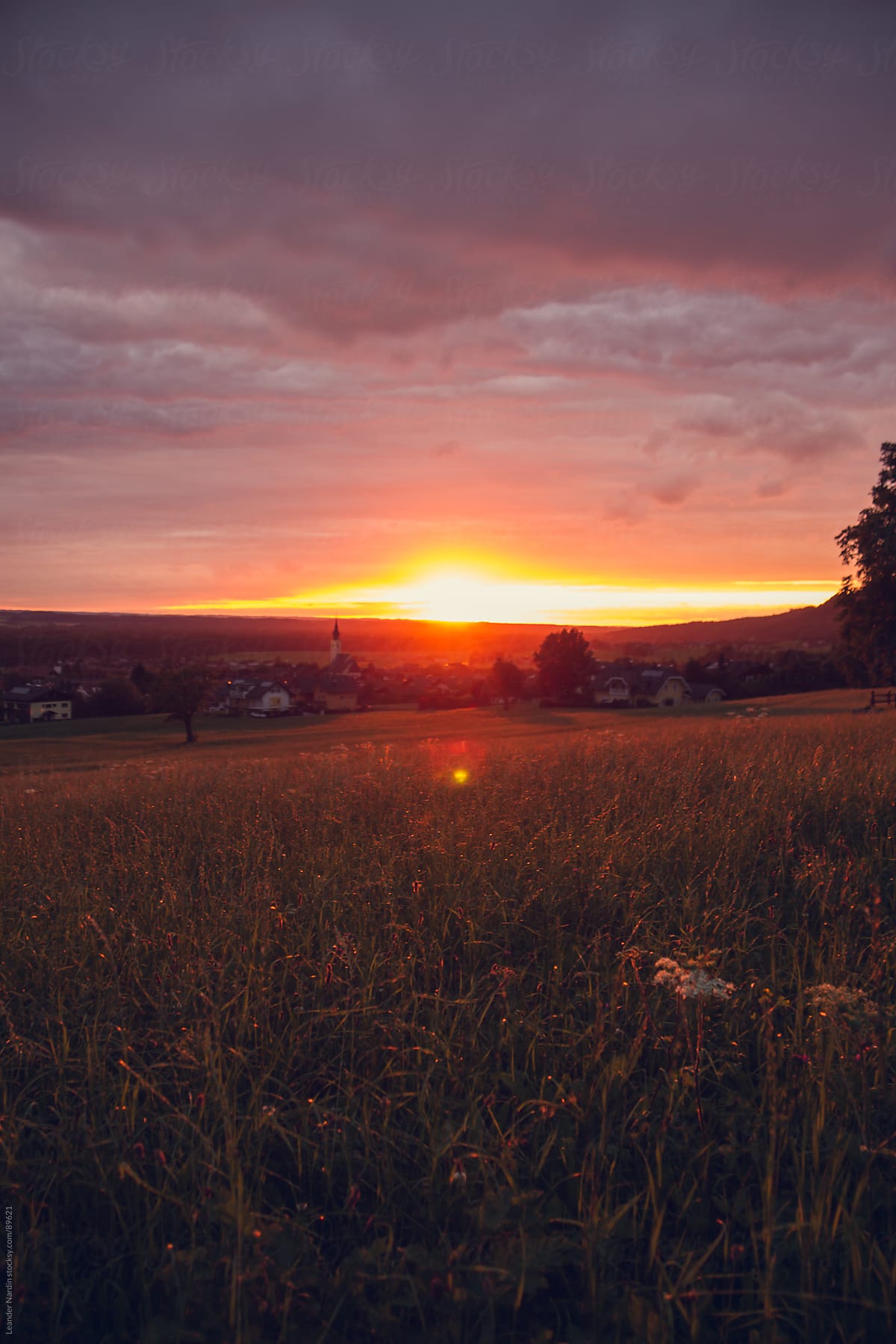 Sunset over a small village with grassy landscape