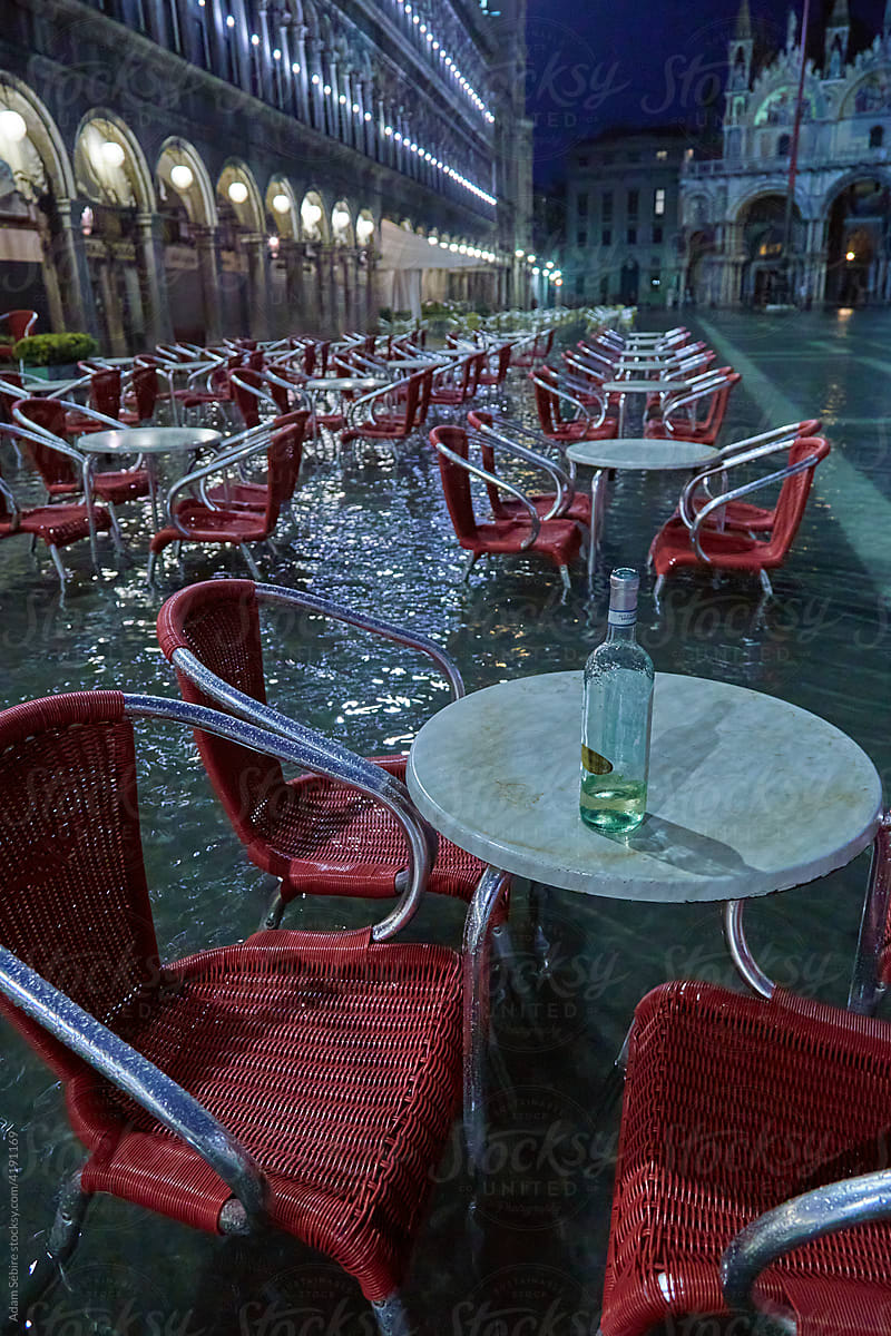 Flooding Venice - empty chairs, no tourists, abandoned bottle