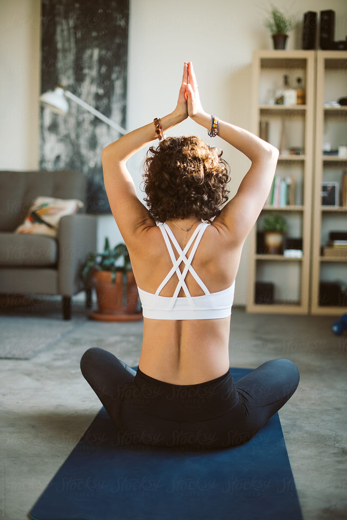 Young fit woman does yoga in her bright city loft.