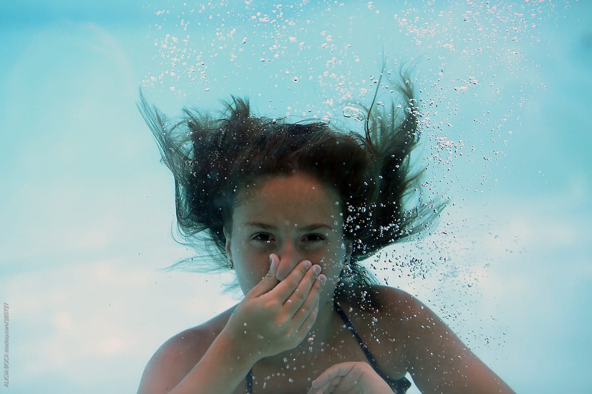 A Girl Holding Her Breath While Swimming Underwater By Stocksy Contributor Alicia Bock Stocksy