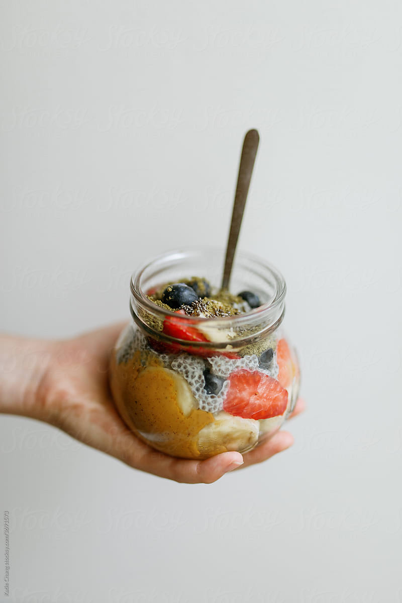 Hand Holding A Cup of Chia Seed Pudding Fruit